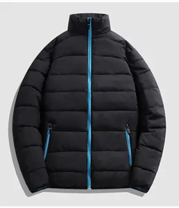 Close-up detail of the black winter puffer jacket featuring a contrast vibrant blue front zipper.