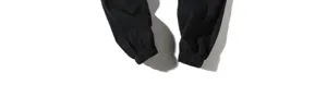 Close-up detail of black men casual trousers elastic cuffs showing fine fabric and neat hem.