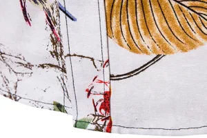 Men's linen shirt fabric detail, close up showing floral print pattern and neat stitching.