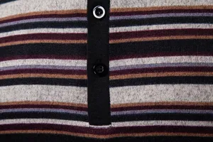 Close-up detail of men's striped knit polo shirt showing fabric texture and buttons.