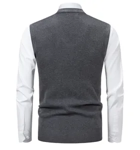 Men's dark grey knit sweater vest layered with white long sleeve shirt autumn casual top.