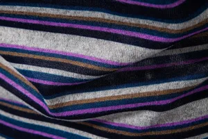 Close-up view of the fine knit striped fabric texture, showing vibrant multi-color patterns.