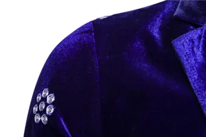 Detail shot of royal blue velvet men's suit jacket featuring exquisite silver floral embroidery.