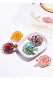 Colorful crystal gravel resin tortoise figurines arranged on a white dish for decor.