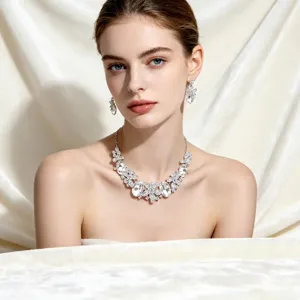 Elegant crystal bridal jewelry set including necklace and floral earrings shown on model