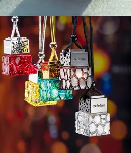 Close-up of geometric glass car perfume bottles with hanging cords for aromatherapy