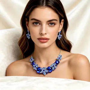 Macro view of elegant blue crystal floral necklace and matching earrings worn by model