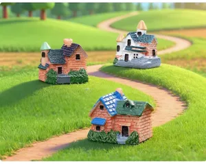 Detailed view of three miniature resin house models for fairy garden micro landscapes.