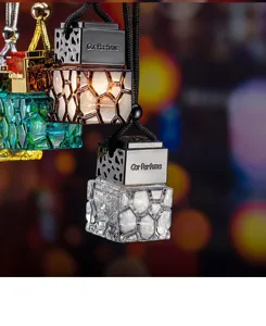 Detail shot of faceted water cube glass car perfume hanging bottles with metallic caps