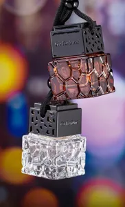 Close-up of water cube textured glass car perfume bottles with black engraved caps