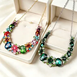 Detailed macro view of two bridal crystal necklaces with colorful flower motifs and gems