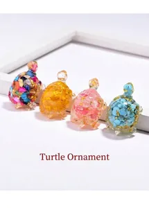 Close-up detail of four crystal resin turtle figurines with stones and gold flakes