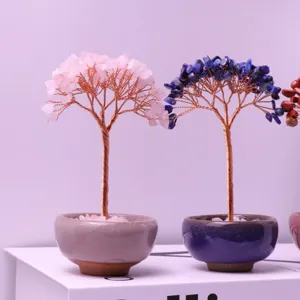 Close-up of rose quartz and lapis lazuli crystal money trees in decorative ceramic cups