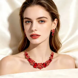 Close-up view of an elegant red crystal necklace and floral earrings set for bridal wear