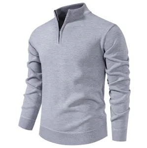 Detail view of men's solid color quarter zip knit sweater, stand collar and ribbed hem design.
