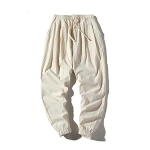 Men's casual loose fit linen harem trousers in light beige with elastic drawstring waist.