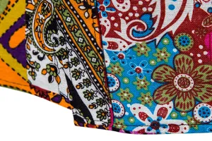 Men's casual linen shirt detail close-up, vibrant ethnic paisley floral patchwork fabric.