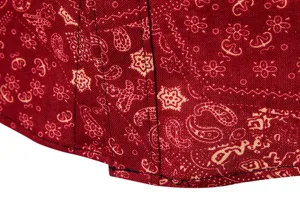 Detail shot of men's ethnic paisley print linen casual long sleeve shirt fabric texture and stitching.