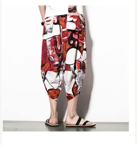 Detailed view of men's ethnic print loose cropped pants, casual drop-crotch summer style.