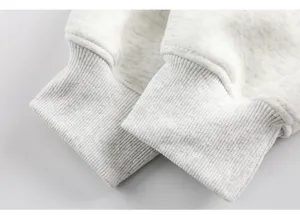 Close-up detail of grey heather sweatshirt ribbed cuffs, premium quality cotton blend.