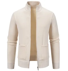 Close-up detail of the beige knitted zip cardigan showing collar, zipper, and pocket.