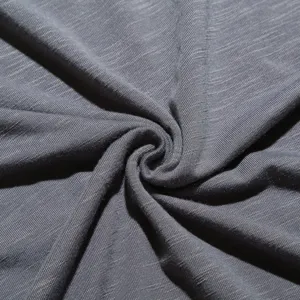 Macro close-up detail view of grey men short sleeve t-shirt soft knitted fabric texture.