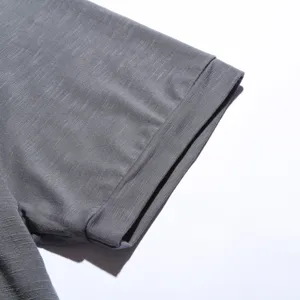 Men grey short sleeve t-shirt fabric detail close up showing fine knit texture and neat stitching.