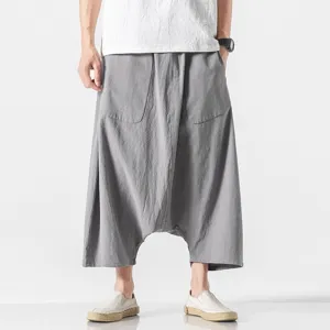 Detailed view of men loose dropped crotch harem pants in grey, casual summer cropped style.