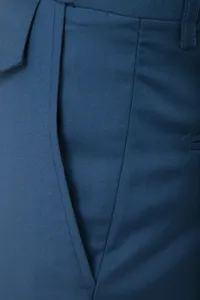 Men's business casual suit pants fabric detail view showcasing textured blue twill fabric.