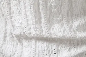 Close-up of white jacquard long sleeve shirt fabric texture, breathable men's top detail.