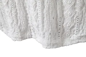 Close-up detail of white jacquard breathable fabric, showing texture and high-end design.