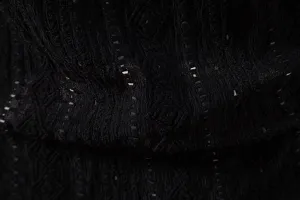 Close-up of men's black jacquard shirt fabric with geometric texture and breathable design.