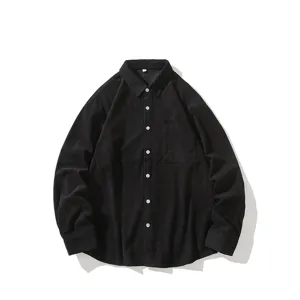 Detailed view of the black corduroy fabric, long sleeve texture and chest pocket design.