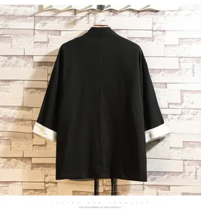 Detail shot of mens traditional Chinese style black kimono cardigan with contrasting white cuffs and collars.