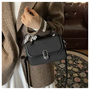 Classic black textured crossbody shoulder bag with scarf handle design for women daily wear.