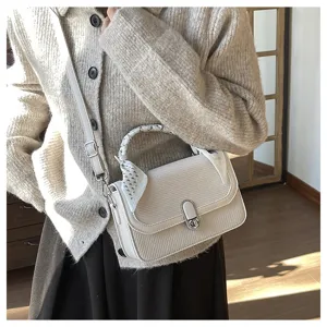Elegant woven shoulder bag for women, stylish crossbody handbag with chic scarf handle.