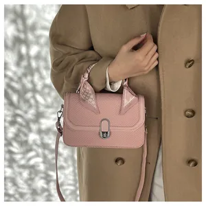 Pink textured crossbody bag with elegant scarf handle, trendy casual small shoulder bag for women.