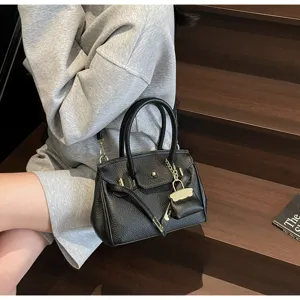 Sac à main classique en cuir noir pour femme, élégant cabas avec quinerie dorée.
