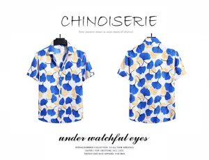 Detail view of men's short sleeve shirt featuring blue yellow ginkgo leaf print for summer.