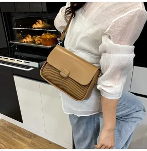 Trendy brown shoulder bag with chic pleated design and flap closure. Ideal for daily commute.
