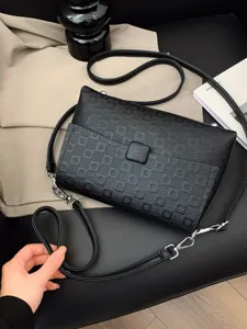 Black leather crossbody bag for women, stylish geometric pattern shoulder bag with flap design.