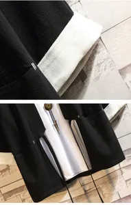Detail shot of Chinese style men's black cardigan sleeve and contrast front tie design.