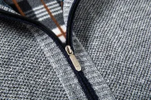 Men's thermal knit cardigan detail view featuring a classic plaid lining and durable zip.