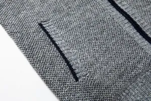 Detailed view of men's grey knit cardigan sweater showcasing fabric texture and pocket.