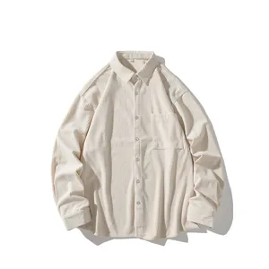 Close-up detail of the beige corduroy fabric texture and button closure on the shirt.