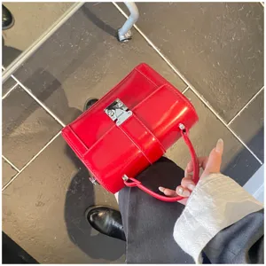 Red patent leather box handbag for women, stylish top handle cross-body shoulder bag for daily commute.