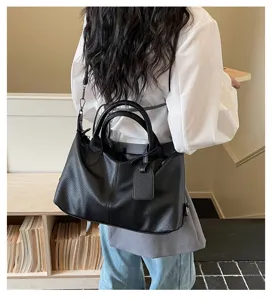 Detailed view of the black soft leather vintage tote bag, stylish shoulder and crossbody style.