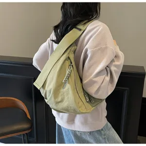 Detail view of the lightweight nylon crossbody dumpling bag with wide strap for daily commuting.