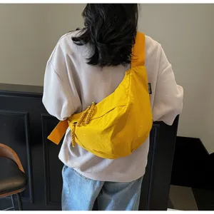 Large capacity yellow nylon crescent crossbody bag with wide strap, casual commuter bag.