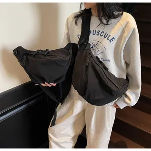 Large capacity nylon dumpling bag for women, casual wide strap crossbody bag for commute.